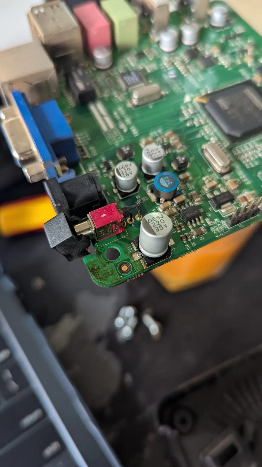 A close view of a green circuit board shows capacitors, connectors and other components.